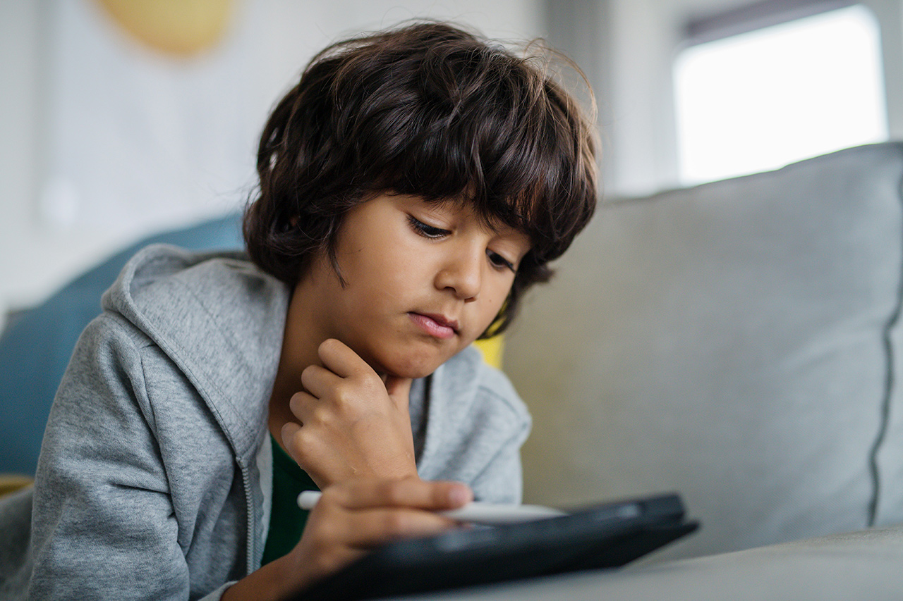 Young student exploring digital technology with a mentor